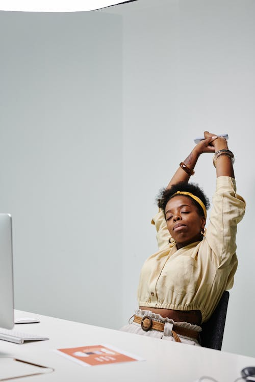a woman taking a short-break from work and doing some stretching