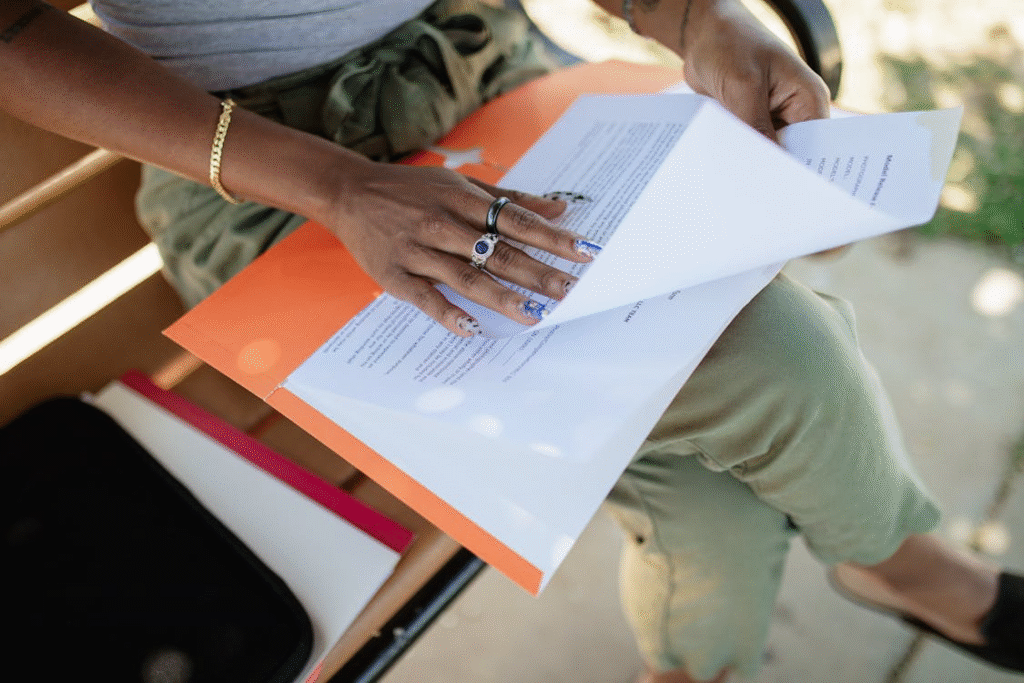 a woman holding some documents