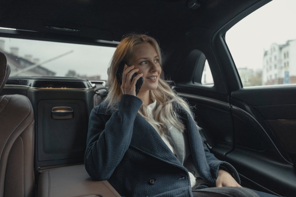 a woman talking on the phone at the back of the car