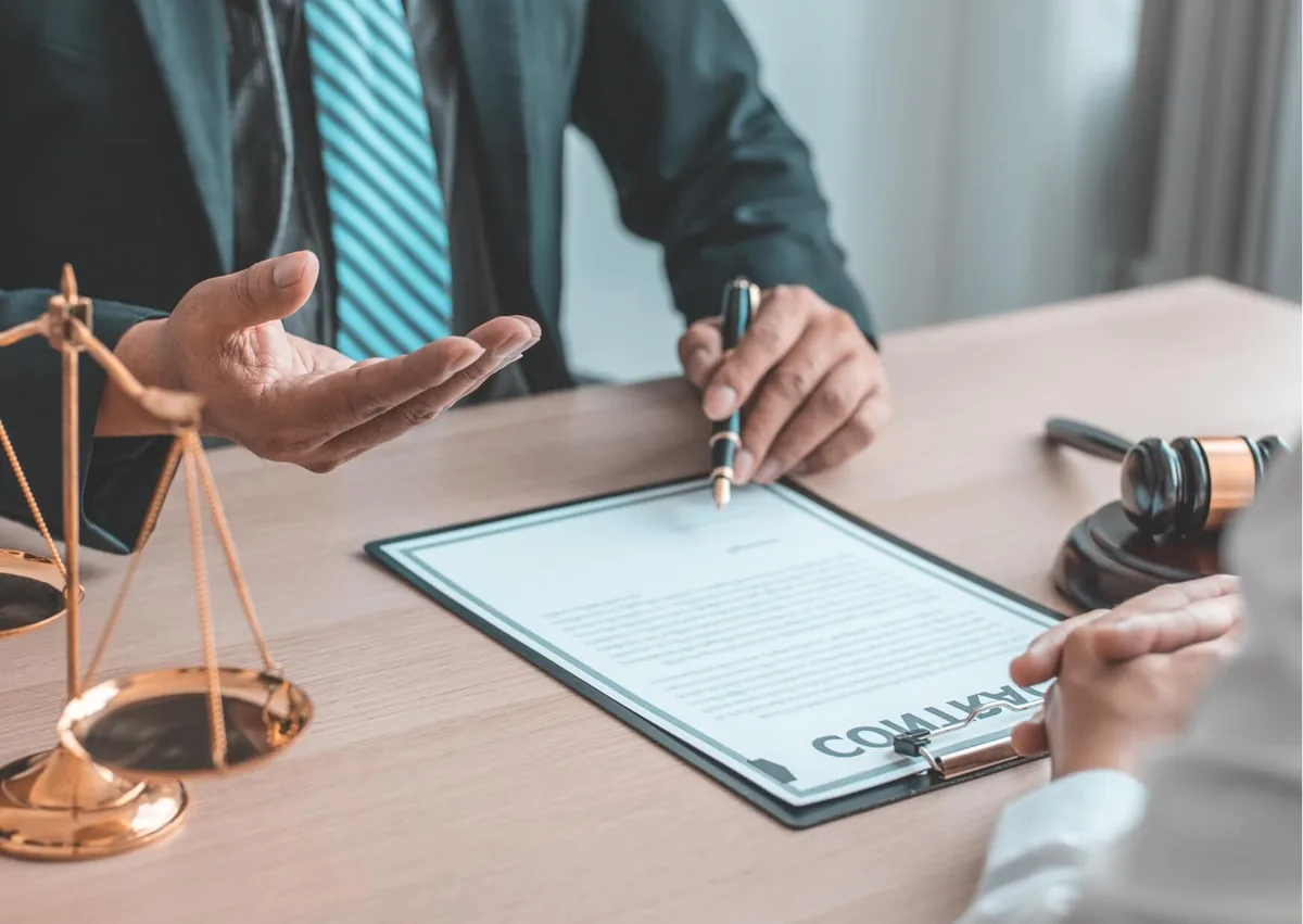 Employment lawyer reviewing an employment contract with a worker during a consultation about constructive termination and workplace rights.