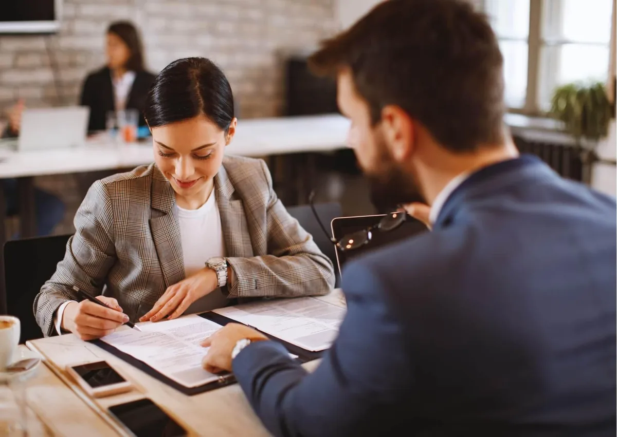 Employee reviewing workplace documents with an employment lawyer to discuss employee monitoring laws and privacy rights at work.