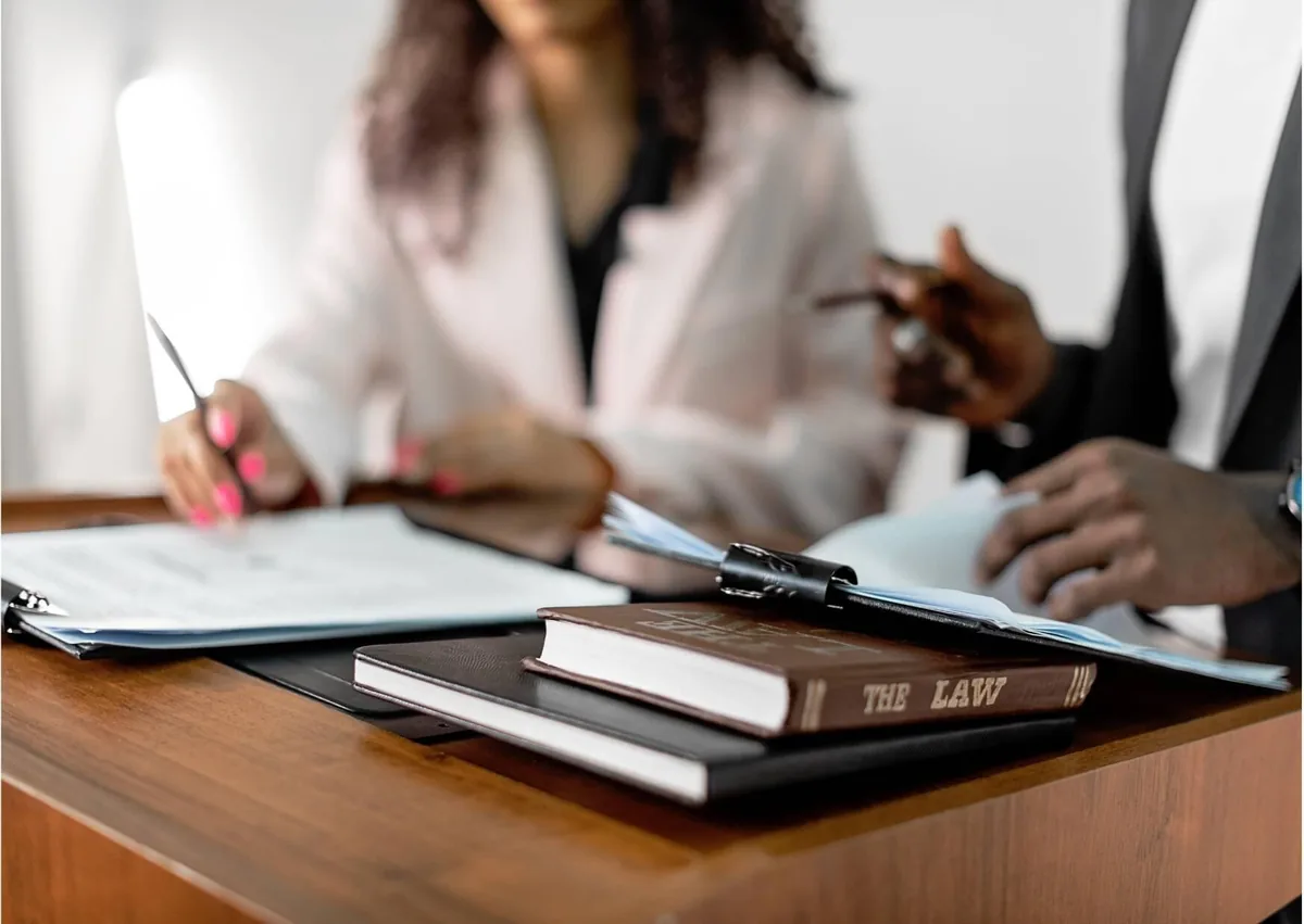 Employer and employee reviewing workplace documents during the interactive process to discuss reasonable accommodations under employment law.